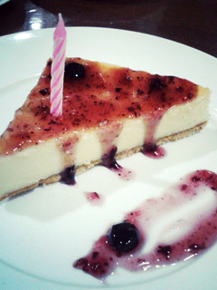 A picture of Traditional Cheesecake with Crust and Blueberry Sauce.