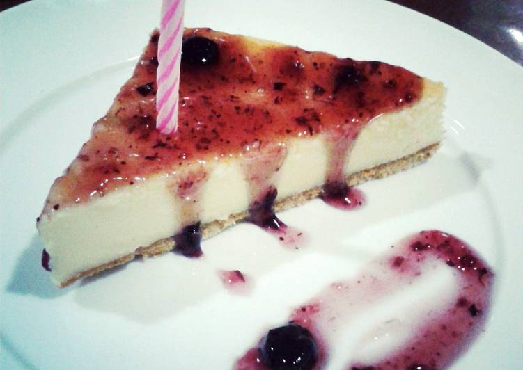 Traditional Cheesecake with Crust and Blueberry Sauce