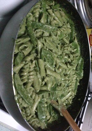 A picture of fusilli with spinach and basil pesto and snow peas pasta.
