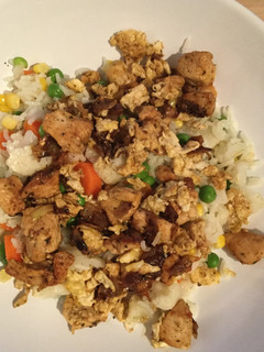 A picture of Fried chicken and rice with vegetables - Chinese cuisine influence .