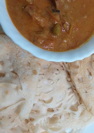 A picture of Jallar Appam (net appam) With Chicken Curry.