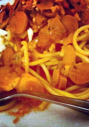 A picture of hot dog and chicken breast meat spaghetti.