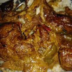 A picture of Smothered pork steaks n gravy w/ rice.