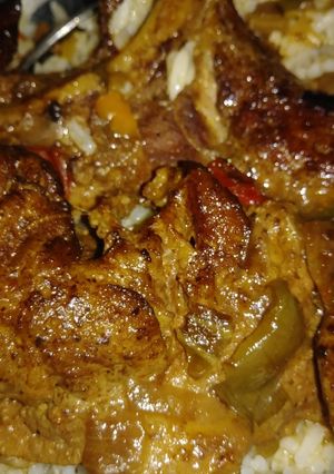 A picture of Smothered pork steaks n gravy w/ rice.