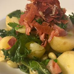 A picture of Crispy Serrano Ham with Kale and Broad Beans.