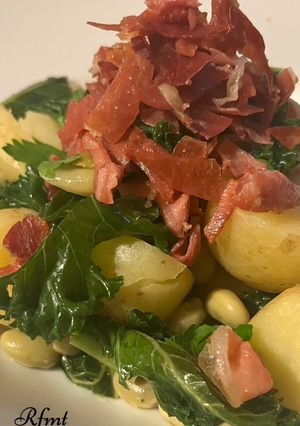 A picture of Crispy Serrano Ham with Kale and Broad Beans.