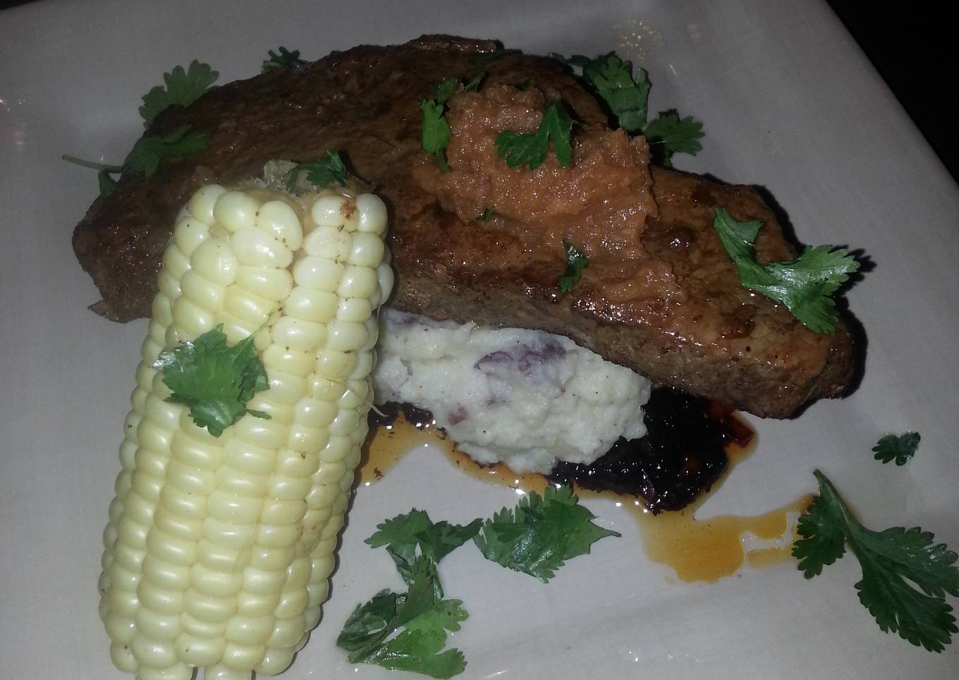 Seard NY strip with pan sauce garlic mash potatoes and corn on the cob