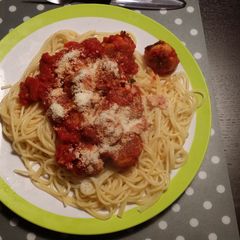 A picture of Spaghetti with fish meat balls.