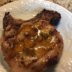 A picture of Grilled Pork Chop with a Peach Preserves Jalapeño Glaze.