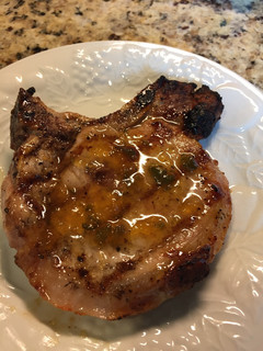 A picture of Grilled Pork Chop with a Peach Preserves Jalapeño Glaze.