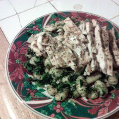 A picture of Gnocchi with greens n grilled chicken.