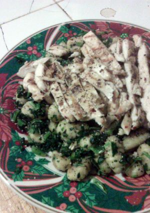 A picture of Gnocchi with greens n grilled chicken.
