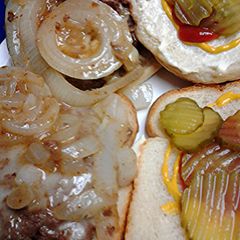 A picture of Brie burgers and onions.