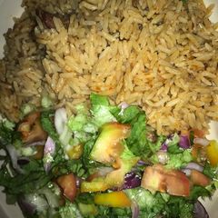 A picture of Jallof rice and salad.