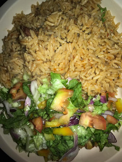 A picture of Jallof rice and salad.