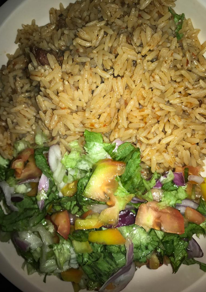 A picture of Jallof rice and salad.