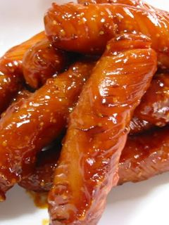 A picture of Wiener Sausages Covered in Ketchup.