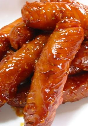 A picture of Wiener Sausages Covered in Ketchup.