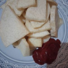 A picture of Fried yam with ketchup.