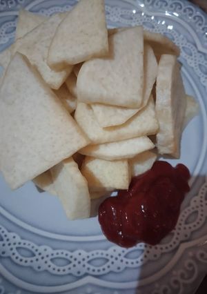 A picture of Fried yam with ketchup.