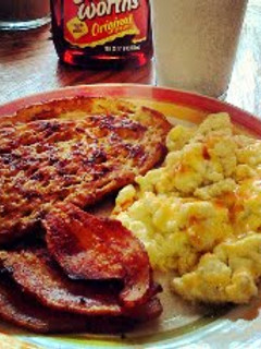 A picture of Sweet & Sourdough French Toast w/ Eggs 'n Bacon.