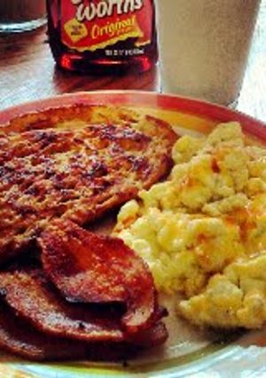 A picture of Sweet & Sourdough French Toast w/ Eggs 'n Bacon.