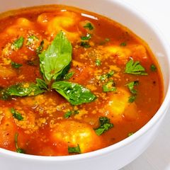A picture of Four Cheese Ravioli in Tomato Broth.