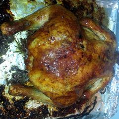 A picture of Roast chicken with lots of seasonings.