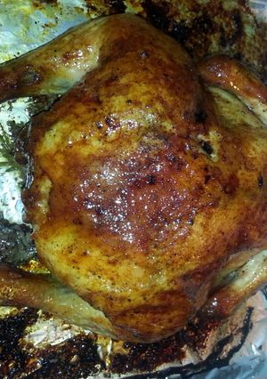 A picture of Roast chicken with lots of seasonings.