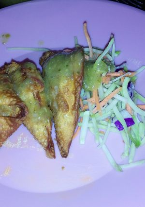 A picture of Fried Pork Wontons and Green Salsa.