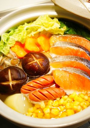 A picture of Salt and Butter Hot Pot with Salmon and Vegetables.