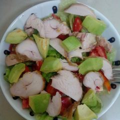 A picture of Grilled Chicken on a bed of lettuce.