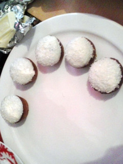 A picture of mini chocolate cupcakes with coconut rasp..
