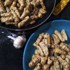 A picture of Italian potato gnocchi in cream herb sauce.