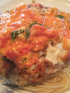 A picture of Farewell Parmesan Crusted Chicken w/light Basil, Tomato, Scampi Cream Sauce.