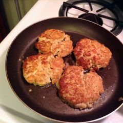 A picture of Salmon Patties And Dill Sauce.