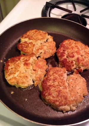 A picture of Salmon Patties And Dill Sauce.