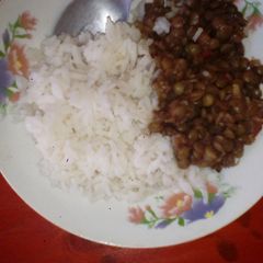 A picture of Boiled rice with green lentils.