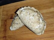 Una foto de empanada bechamel