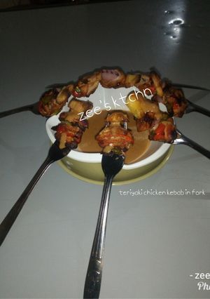 A picture of Teriyaki chicken kebab in fork.