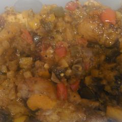 A picture of Tasty Island Chicken with fried cabbage, cornbread and rice.