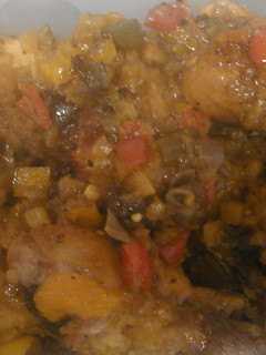A picture of Tasty Island Chicken with fried cabbage, cornbread and rice.