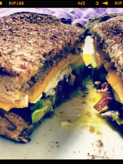 A picture of Bacon, egg, cheese and avocado sandwich.