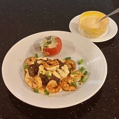 A picture of Seared Steak and Shrimp with Sriracha Hollindaise and Roasted Tomatoes.