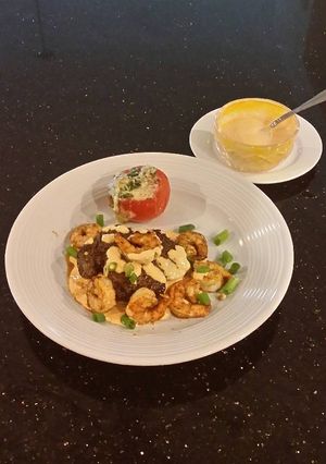 A picture of Seared Steak and Shrimp with Sriracha Hollindaise and Roasted Tomatoes.