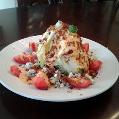 A picture of BLT Wedge Salad With Blue cheese and Homemade Zesty Russian Dressing.