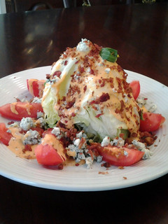 A picture of BLT Wedge Salad With Blue cheese and Homemade Zesty Russian Dressing.