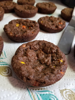 A picture of Chocolate Reeses pieces cookies in muffin tins.