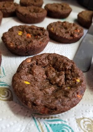 A picture of Chocolate Reeses pieces cookies in muffin tins.