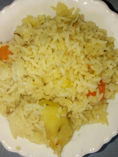 A picture of One pot rice with potatoes and carrots.